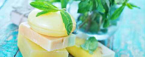 soap and mint leaves on the wooden table